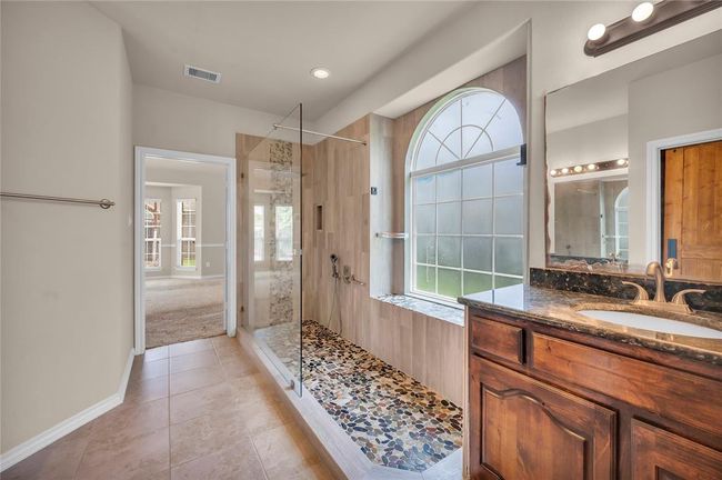 Experience luxury in the primary bath with a newly upgraded walk-in spa shower. | Image 23