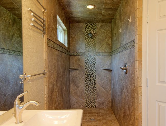 Bathroom featuring a sink and tiled shower | Image 20