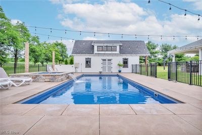 View of pool featuring an in ground hot tub, pool water feature, and a patio | Image 3