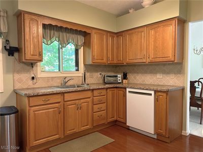 The Eat in Kitchen has a vaulted ceiling and ample cabinet space and countertop space. | Image 2