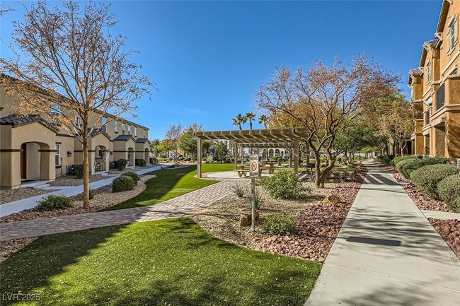 View of community featuring a residential view, a lawn, and a pergola | Image 13