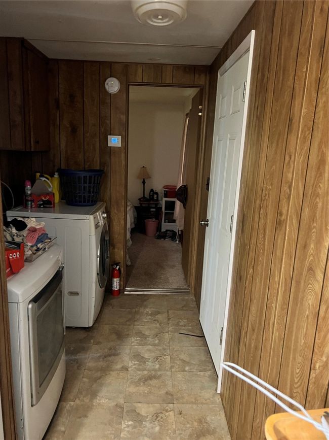 Laundry area with washer and dryer and wooden walls | Image 29