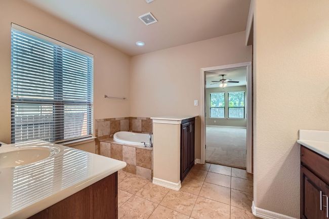 Bathroom featuring vanity, a garden tub, tile patterned floors, and a ceiling fan | Image 18