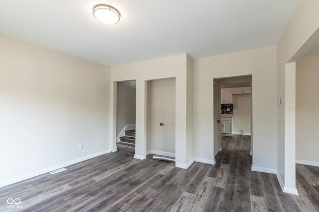 unfurnished bedroom featuring baseboards, a closet, and dark wood-style flooring | Image 23