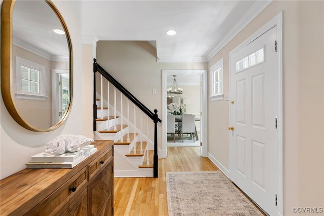 Entrance foyer featuring crown molding, freshly refinished hardwood floors, and recessed lighting. This view is from the living room/office looking toward the dining room. | Image 6