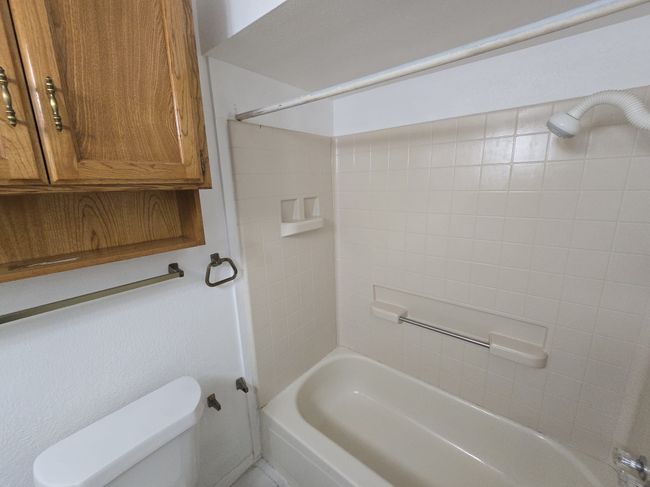 Full bath featuring shower / bath combination and toilet | Image 12