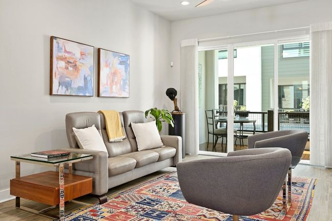 Living room on the main floor. Open to all areas of the main floor. Opens directly to a balcony. | Image 15