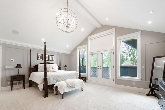 Bedroom featuring light carpet, vaulted ceiling with beams, access to outside, french doors, and a notable chandelier | Image 22