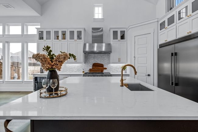 Kitchen featuring stainless steel built in refrigerator, hardwood / wood-style floors, a healthy amount of sunlight, and wall chimney range hood | Image 14