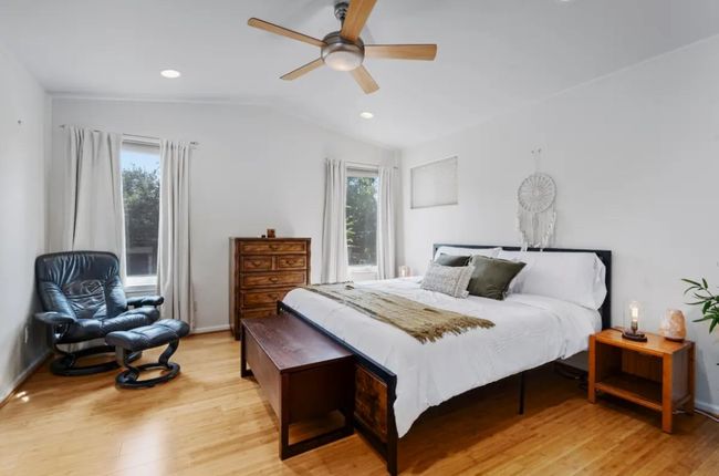Bedroom featuring light wood-type flooring, vaulted ceiling, ceiling fan, and recessed lighting | Image 13
