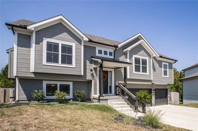 Bi-level home featuring a front yard and a garage | Image 3