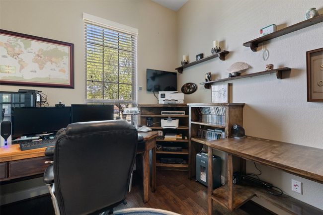 Dedicated home office with French doors, custom wood built-ins, and wired sound provides the ideal space for remote work | Image 29