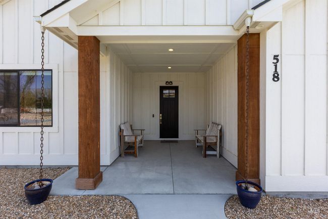 Property entrance featuring board and batten siding | Image 34