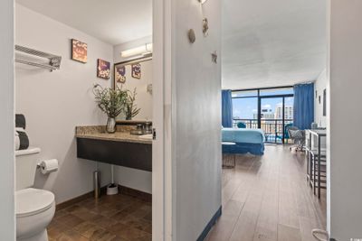 Bathroom featuring vanity with extensive cabinet space, toilet, and expansive windows | Image 2