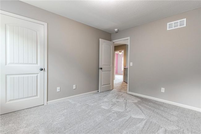 Unfurnished bedroom with light carpet | Image 33