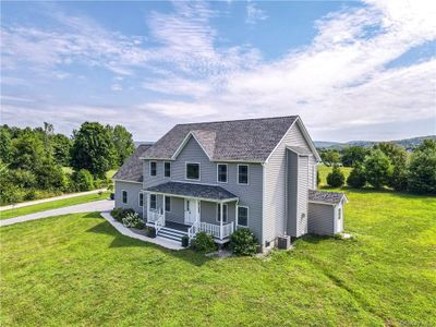 View of front of home featuring central AC and a front lawn | Image 1