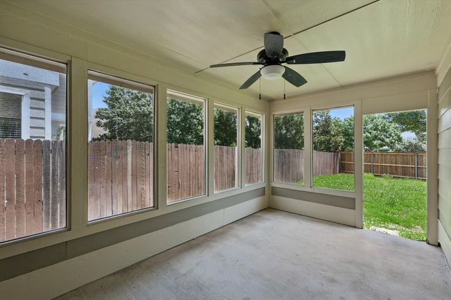 Unfurnished sunroom featuring ceiling fan and healthy amount of natural light | Image 25