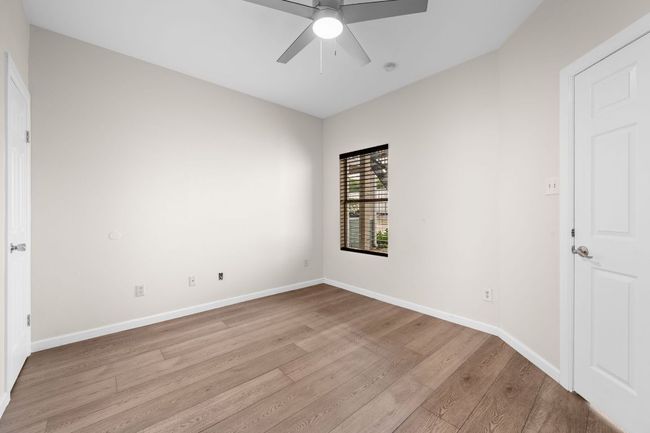 Bedroom featuring wood finished floors, baseboards, and ceiling fan | Image 9