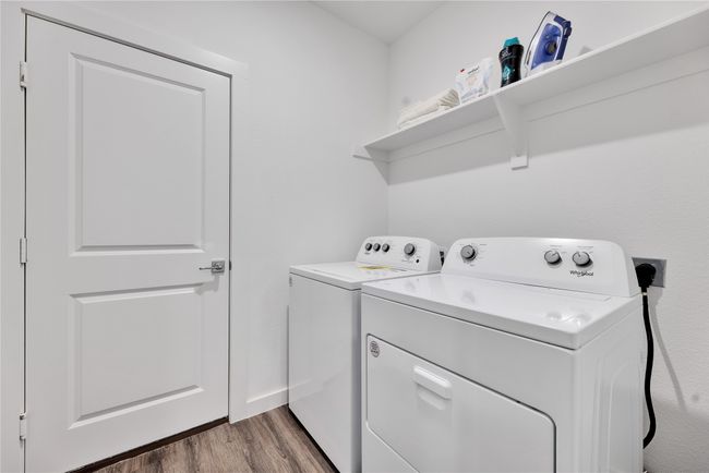 Laundry room with laundry area, wood finished floors, and washer and dryer | Image 27