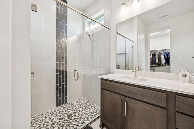 Full bath with a shower stall, vanity, and a spacious closet | Image 18
