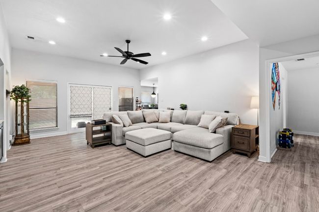 Living room featuring baseboards, recessed lighting, light wood-style floors, and ceiling fan | Image 4