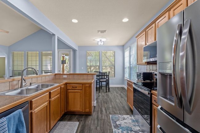 Kitchen with dark wood finished floors, and stainless steel appliances | Image 16
