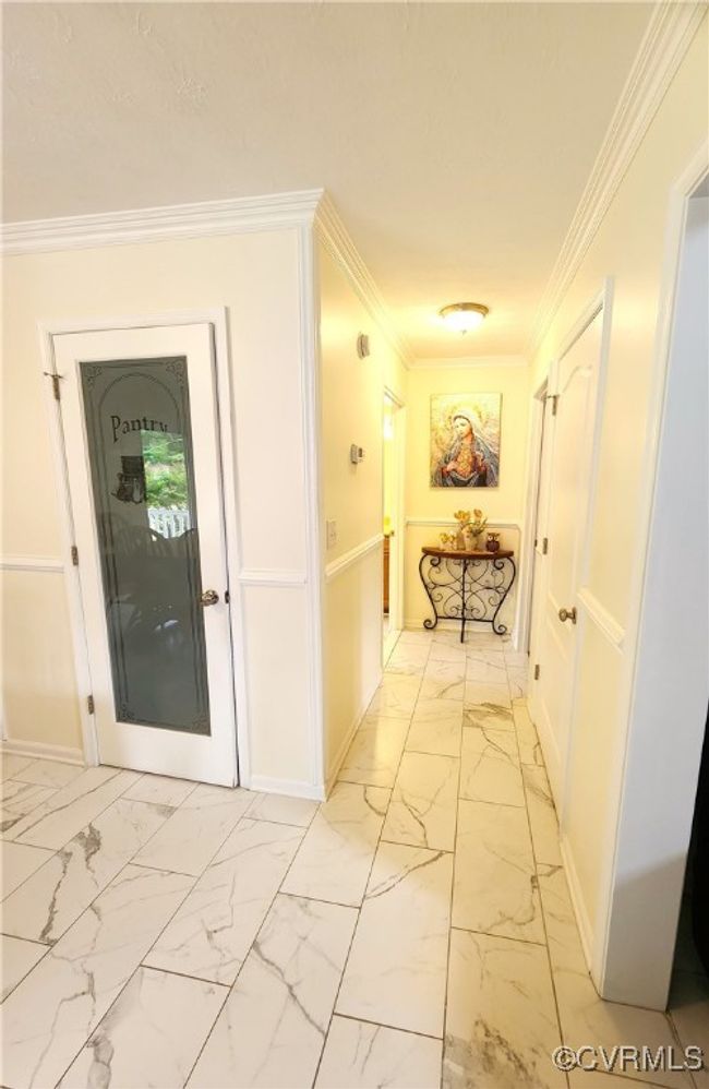 Corridor with light marble finish floors and crown molding | Image 11