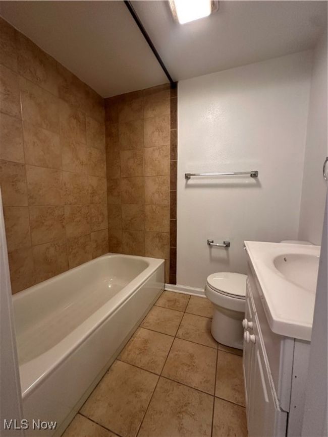 Full bathroom with baseboards, toilet, tile patterned flooring, and vanity | Image 36