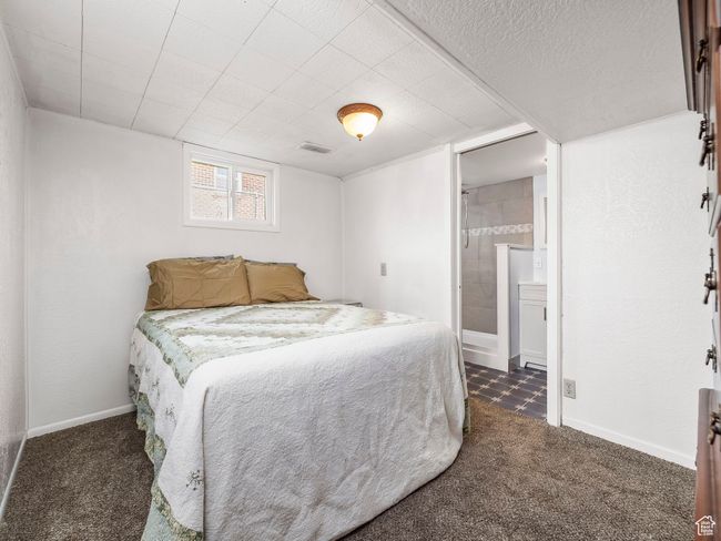 Bedroom with dark colored carpet and ensuite bath | Image 16