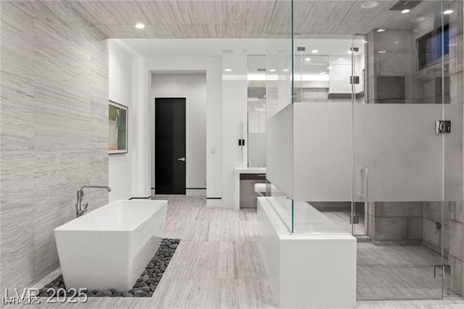 Bathroom with tile walls, a freestanding tub, and a shower stall | Image 37