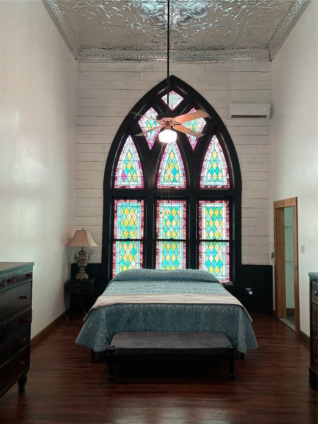 Bedroom with wood walls, an ornate ceiling, and dark wood-type flooring | Image 13