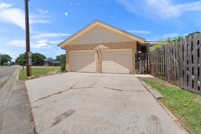 2-car Garage featuring driveway. Driveway is on the right side of the home. | Image 34