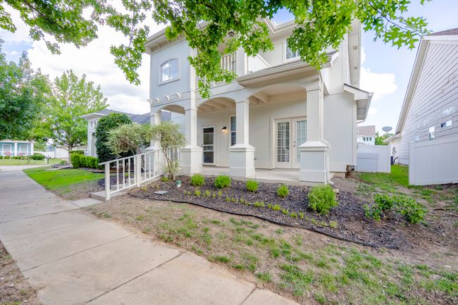 View of front of home with a porch, a balcony, french doors, and stucco siding | Image 4
