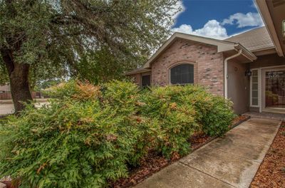 Beautiful mature tree & lush landscaping leads you to the entrance. | Image 3