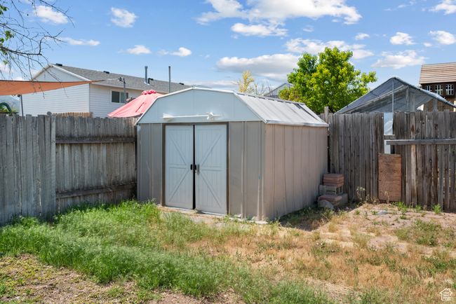 View of shed featuring a fenced backyard | Image 16