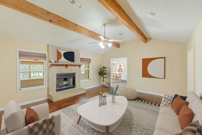 Main living room with beautiful beams, hard wood floors and fresh paint. picture is virtually staged. | Image 5