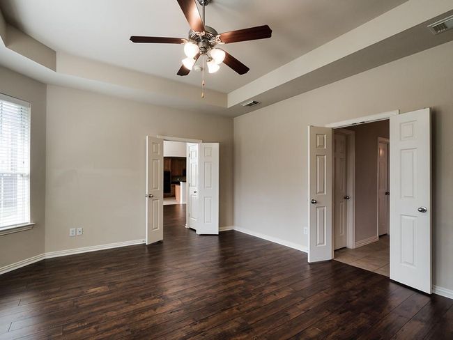 Unfurnished bedroom featuring wood finished floors, baseboards, and a ceiling fan | Image 29