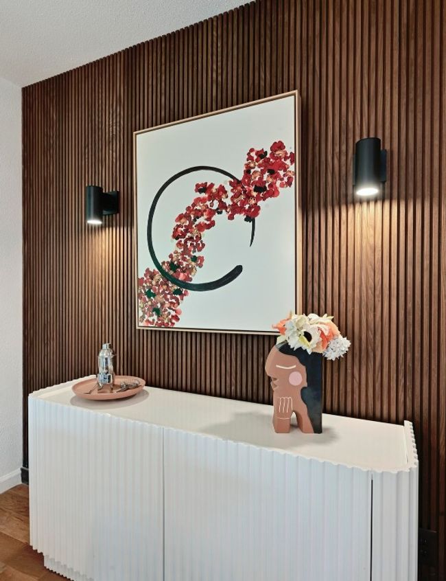 A striking wood accent wall with sconce lighting is sure to impress your dinner guests. | Image 18