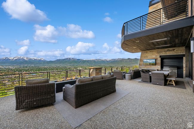 View of patio / terrace with an outdoor living space with a fireplace, a balcony, and outdoor dining area | Image 19