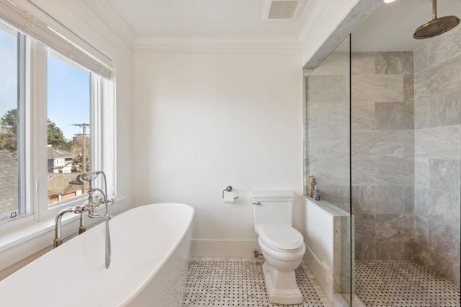 Full bath with plenty of natural light, visible vents, tiled shower, and ornamental molding | Image 15