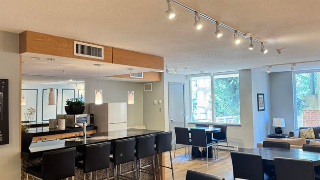 Interior space with rail lighting, freestanding refrigerator, visible vents, and light wood finished floors | Image 7