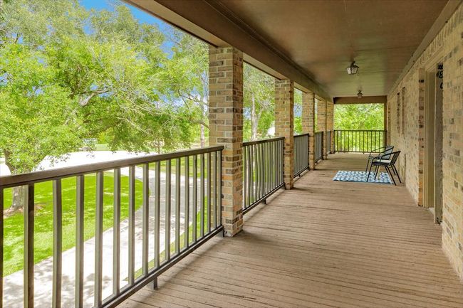 A spacious second-level balcony spans the entire from of home. | Image 28