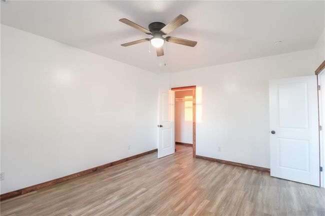 Unfurnished bedroom featuring light wood-type flooring and ceiling fan | Image 25