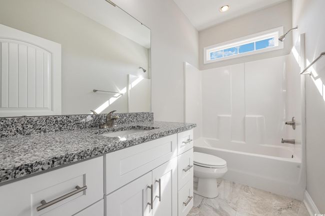 Full bathroom featuring vanity, shower / bathing tub combination, and toilet | Image 25