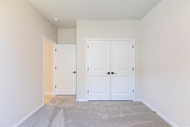 Unfurnished bedroom featuring carpet flooring, baseboards, and a closet | Image 8