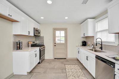 All NEW kitchen and baths in this home! New appliances, new cabinets, new gleaming counter tops! Neutral color palette and nice oversized Restoration Hardware inspired cabinet handles. | Image 2