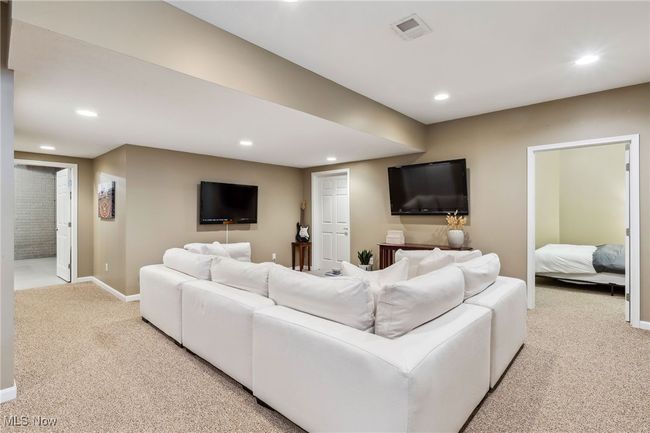 Bright, finished lower level offering the perfect setup for entertaining, watching the game, or relaxing with friends | Image 33