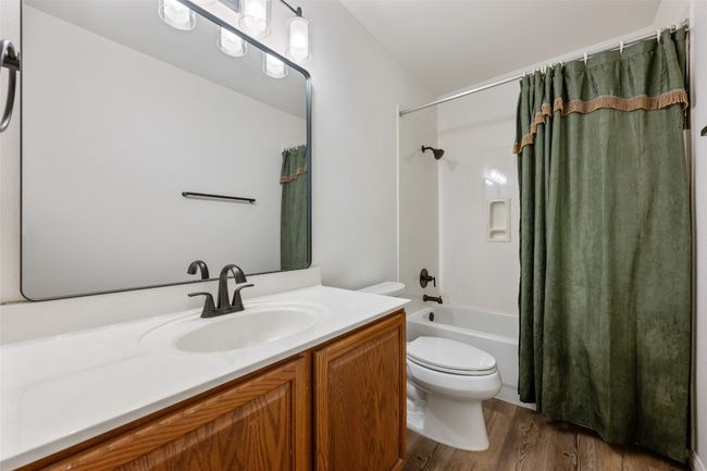Full bathroom with vanity, wood finished floors, and shower / tub combo with curtain | Image 32