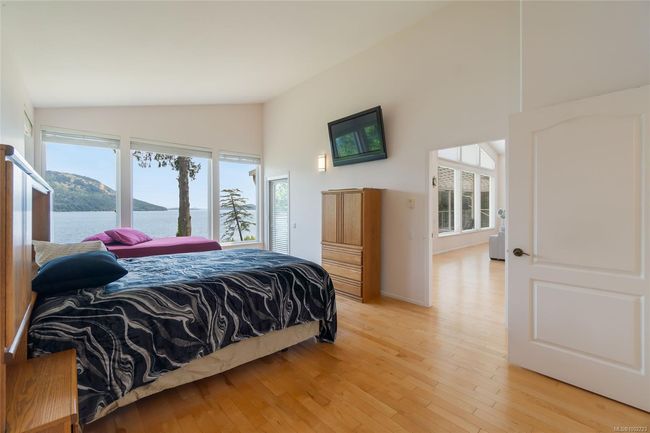 Bedroom with multiple windows, light wood-style floors, and high vaulted ceiling | Image 33
