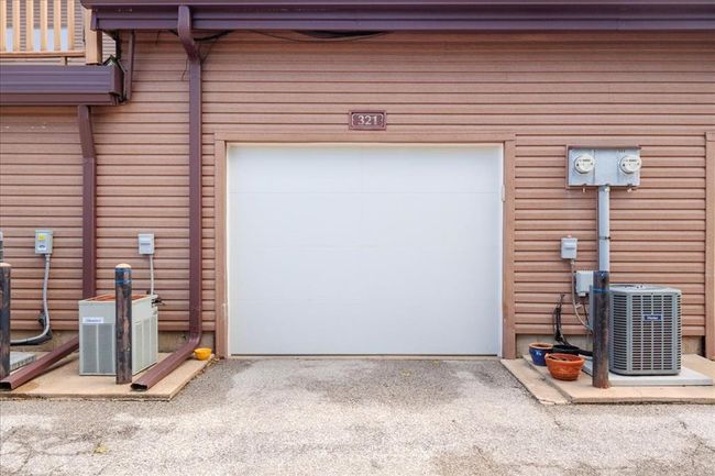Garage with cooling unit and driveway | Image 17